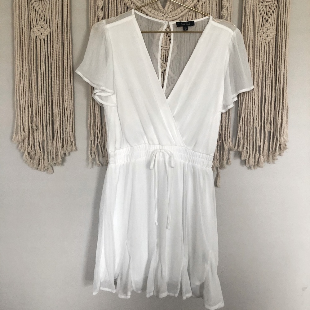 White mini dress with ruffle bottom